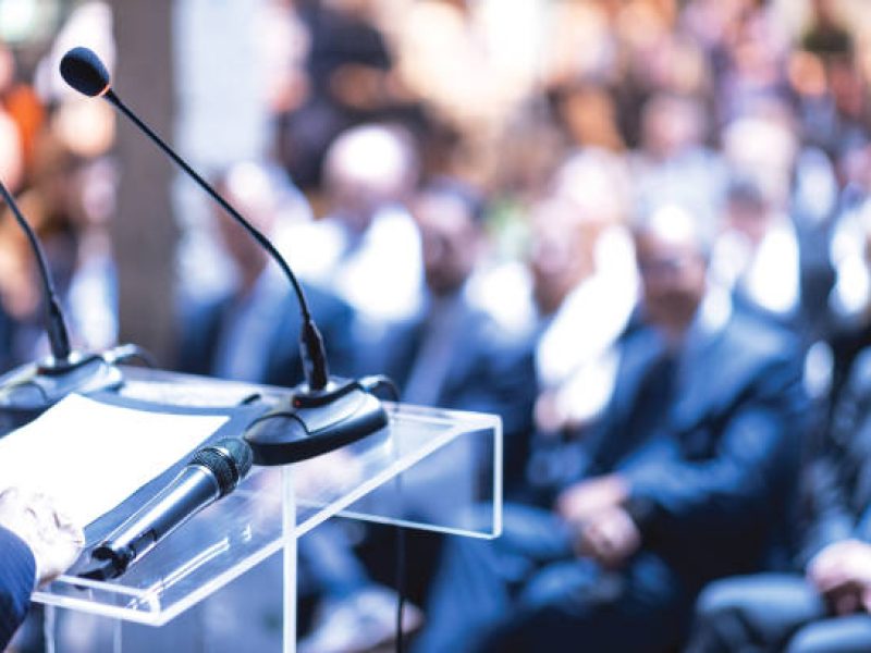 Public speaker at business conference, corporate presentation, workshop, coaching training, news conference, company meeting, public or political event